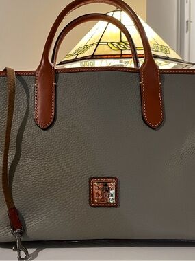 Dooney & Bourke ladies Gray purse with attractive leather trim
